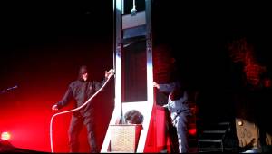 Alice Cooper guillotine stunt. Photo retrieved from https://www.youtube.com/watch?v=RsRQDhBDvgg on December 2, 2014.